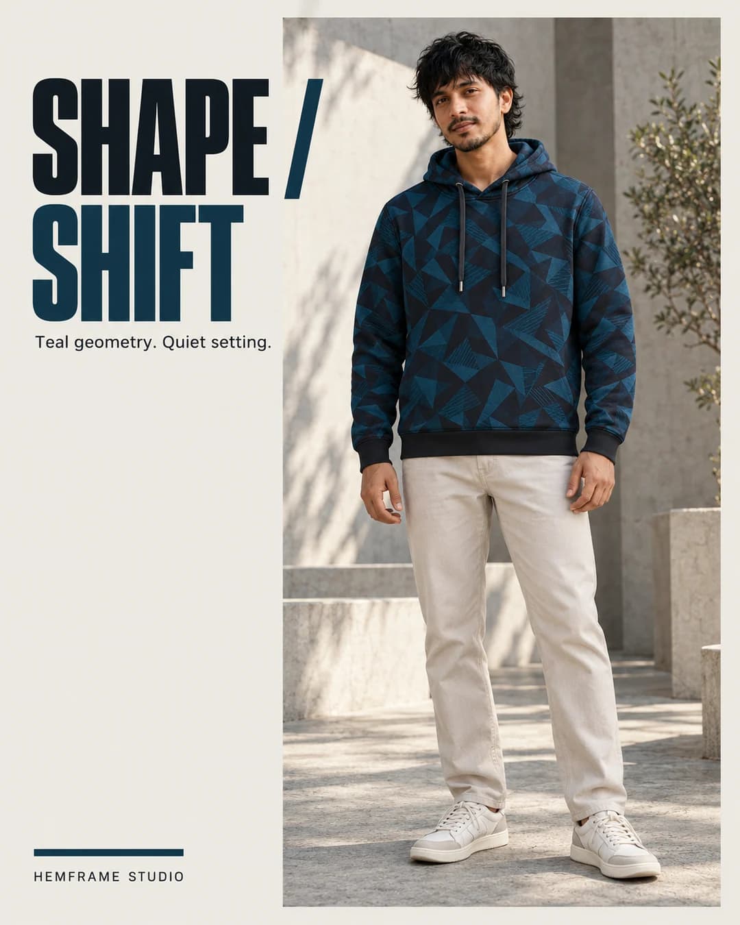 Shape / Shift: Teal geometric hoodie styled against pale concrete