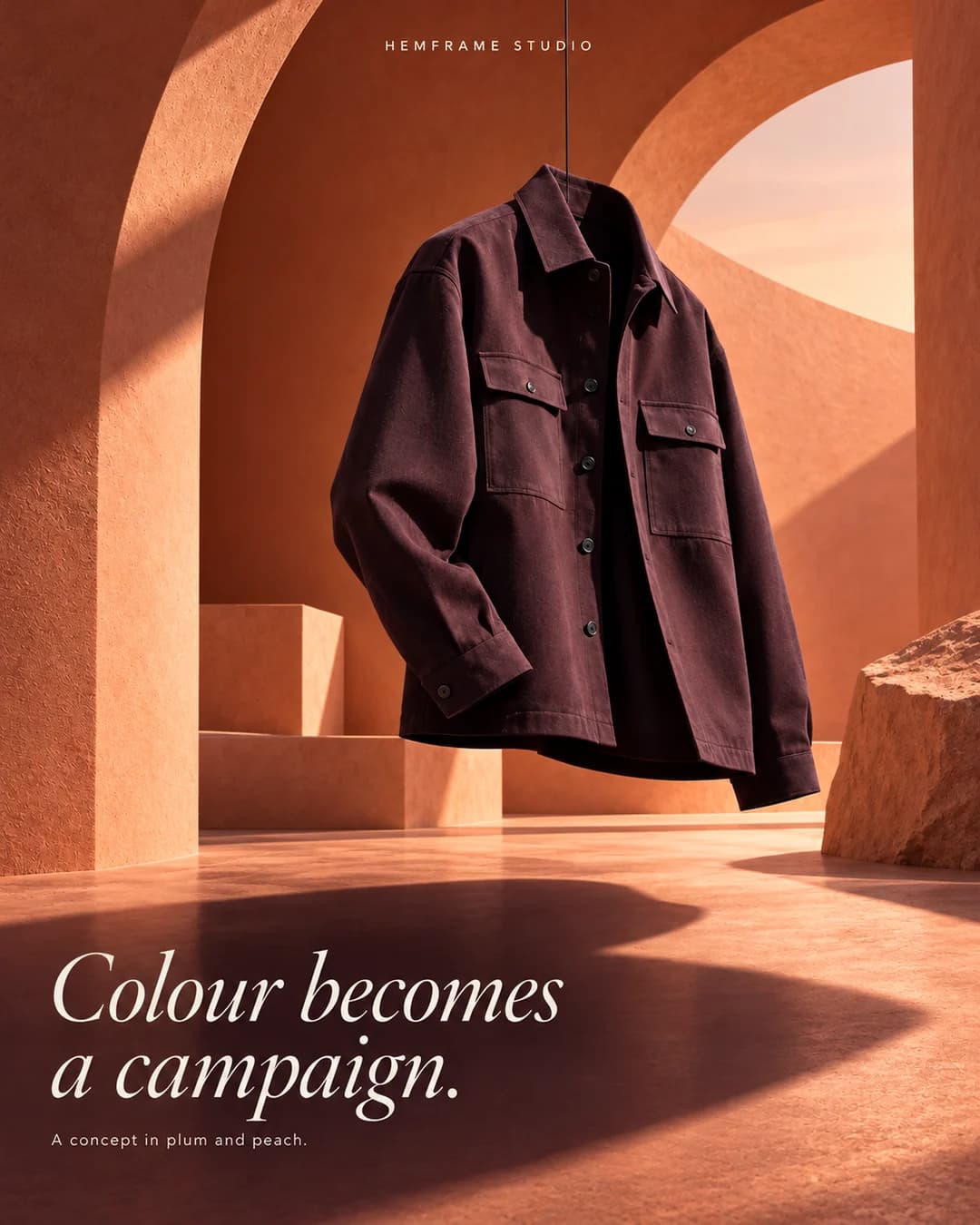 Plum jacket hanging in a warm peach architectural setting with Colour becomes a campaign typography